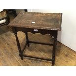 An Edwardian oak side table, the rectangular top with carved border and moulded edge, scalloped