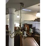 A suite of three brass hanging chandeliers in the Edwardian style, two five arm and one three arm,