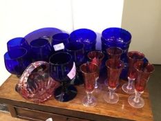 A suite of Bristol blue glassware including six wine glasses, eight bowls and eight plates