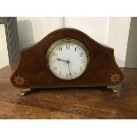 An Edwardian mahogany inlaid mantel clock of dome shape, with white enamel dial and arabic numerals,