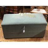 A 1930s/40s upholstered ottoman box, the hinged top in a green fabric, raised on squat ball feet (