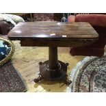 A 19thc rosewood foldover card table, the rectangular top with rounded angles and with baize lined