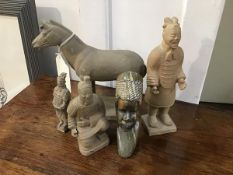 A group of Chinese terracotta army figures, including a Horse, together with a carved African