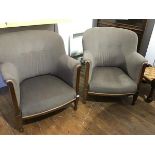 A pair of early 20thc mahogany framed upholstered tub chairs, with curved backs and shaped arms,