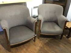 A pair of early 20thc mahogany framed upholstered tub chairs, with curved backs and shaped arms,