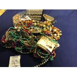 A mixed lot of earrings, beads, brooches etc. (a lot)