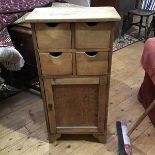 A 20thc pine cabinet, the rectangular top above four drawers over a single panel door (90cm x 45cm x