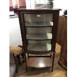 An Edwardian mahogany bow front cabinet, the top with moulded edge above a bow front door, with