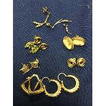 A mixed lot of 9ct gold and yellow metal earrings, including cameo rings, knot rings, hoop earrings,