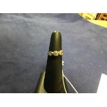 An 18ct gold three stone diamond illusion set ring on yellow metal band marked 18ct (L) (2.3g)