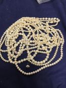 A mixed lot of jewellery including a double length strand of freshwater pearls, together with four
