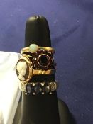 A mixed lot of 9ct gold and yellow metal dress rings, stone set and cameo set (8.1g) (4)