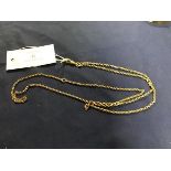 A yellow metal guard chain with dog clip and circular ring to top, unmarked (11.8g)