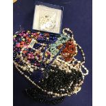 A bag containing a mixed lot of beads including freshwater pearls, mother of pearl, glass and