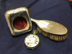 An oversized pocket watch, with nickel case and white enamel dial with roman numerals, fitted in a