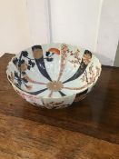 A Chinese porcelain Imari bowl with fluted decoration with radiating vertical bands of flowerheads