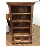 An Indian hardwood open bookcase, the rectangular top with plain frieze above four open shelves,