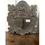 An 18thc style cast bronze wall sundial, the top half featuring Neptune driving a chariot, sundial