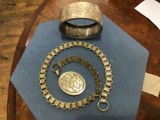 A Victorian engraved white metal bangle, Mary, and a fancy link chain with oval engraved locket (2)