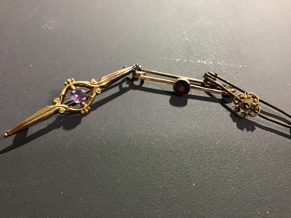 Three Victorian bar brooches including a 9ct gold brooch set amethyst together with a yellow metal