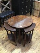 A 1930s walnut circular coffee table with nest of four quarter shaped tables (33cm x 60cm) (a/f)