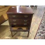 An early 20thc mahogany four drawer music cabinet, the rectangular top with moulded edge above