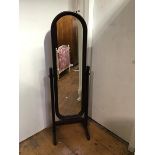A 1970's/80's mahogany framed cheval mirror, the rectangular mirror with arched top, on trestle