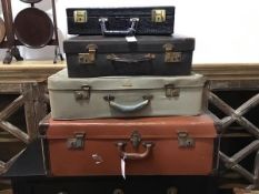 A group of vintage cases including a vinyl brown case, a snakeskin style case, a brown leather