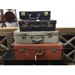 A group of vintage cases including a vinyl brown case, a snakeskin style case, a brown leather