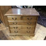 A 19thc style oak chest of drawers, the rectangular top with moulded edge above two short and