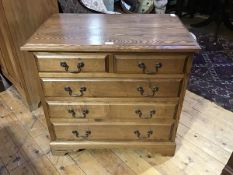 A 19thc style oak chest of drawers, the rectangular top with moulded edge above two short and