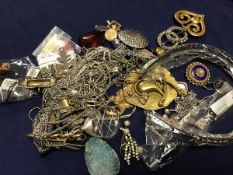 A bag containing a group of costume jewellery including pendants, brooches, earrings etc. (a lot)