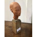 A Musee Du Louvre terracotta bust of Nefertiti on wooden stand, impressed mark to rear, C.B. (23cm)
