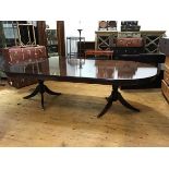 A Swiss reproduction solid mahogany D end dining table, the plain top with reeded edge, above a
