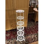 A white enamelled cast metal six tier graduated pot stand. H. 122cm