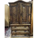 A Continental pitch pine two part linen press, the arched moulded top above a pair of arched