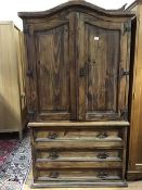 A Continental pitch pine two part linen press, the arched moulded top above a pair of arched