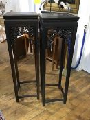 A pair of tall Chinese jardiniere stands, each with square top and pierced frieze incorporating