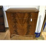 A 1950's serpentine fronted mahogany chest of drawers, the plain top with reeded edge above four