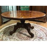 A 19thc. figured walnut breakfast table, the oval top with moulded edge and plain frieze on carved
