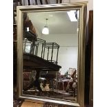 An Edwardian style wall mirror in moulded silver finish frame, and with bevelled plate (94cm x