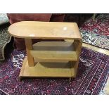 An Art Deco three tier oak side table with bentwood end support and fitted with two open shelves. (