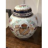 An 18thc style Chinese armorial ginger jar, the central panel with coat of arms, with allover floral