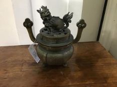 A Chinese bronze censer of circular bellied form, the cover mounted with kylin finial, the body with