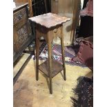 An Edwardian oak plant stand, the top with scalloped edge raised on squat tapered supports united by