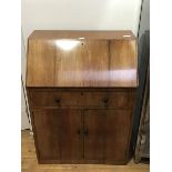 A 1930s/40s mahogany bureau, possibly Heals of London, the plain top above a fall front enclosing