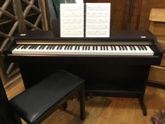 A Yamaha Clavinova CLP-115 electronic keyboard on stand, complete with stool