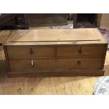 A 19thc beech low bench seat, the panel top above two short and one long drawer, on a plinth base (