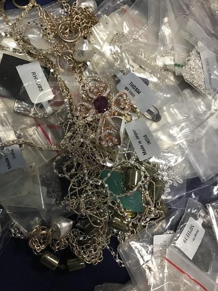 A bag containing a large quantity of white metal chains, pendants, necklaces, predominantly marked