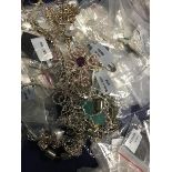 A bag containing a large quantity of white metal chains, pendants, necklaces, predominantly marked